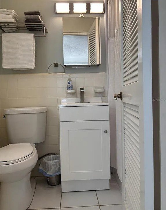 Bathroom vanity and toilet inside Pelican Gardens Unit 8