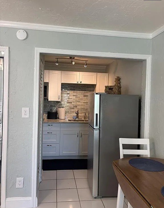 Kitchen entrance and dining table inside Pelican Gardens Unit 8
