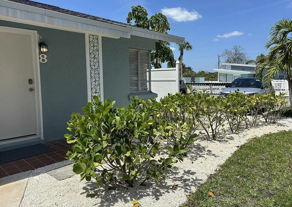 Exterior walkway and landscaping at Pelican Gardens Unit 8