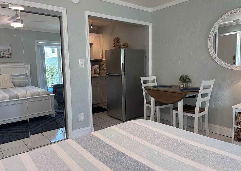 Interior view of Pelican Gardens Unit 8 with dining area and kitchen entrance