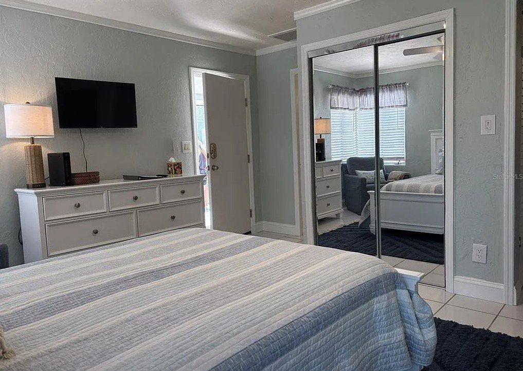 Interior view of Pelican Gardens Unit 8 with bed and television